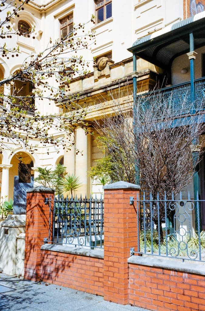 A house with a wrought iron fence and a gate